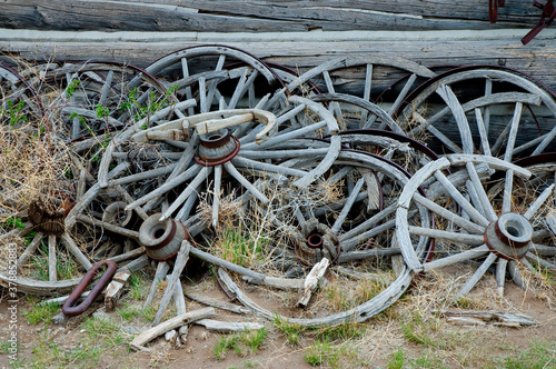 Obraz na plátne Damaged wagon wheel in a ghost town, Old Trail Town, Cody, Wyoming, USA