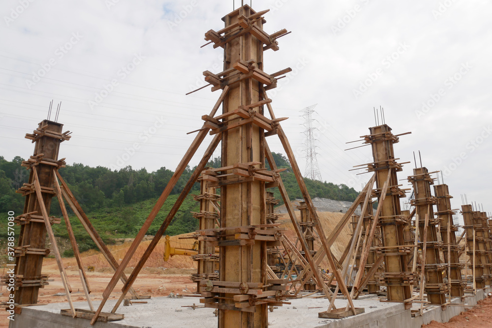 KUALA LUMPUR, MALAYSIA -SEPTEMBER 19, 2020: Column timber form work and reinforcement bar at the construction site. Installed by construction workers. The structure supported by temporary wood support KUALA LUMPUR, MALAYSIA -SEPTEMBER 19, 2020: Column timber form work and reinforcement bar at the construction site. Installed by construction workers. The structure supported by temporary wood support