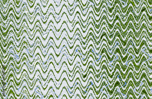 Abstract zigzag pattern with waves in green and white tones. Artistic image processing created by floral photo. Beautiful multicolor pattern for any design. Background image