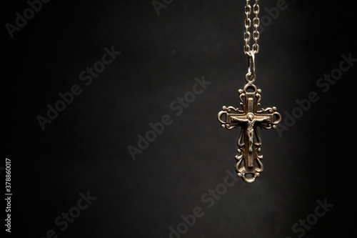 Cross with chain on a dark background.