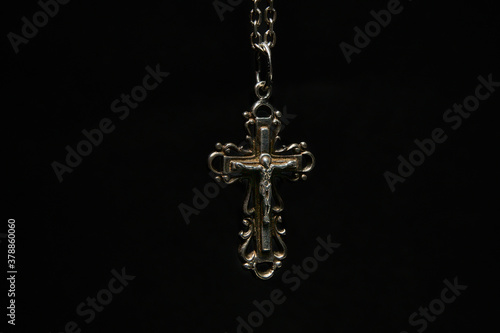 Cross with chain on a dark background.