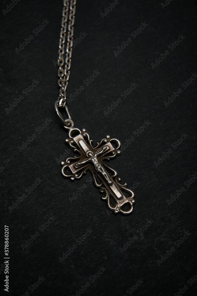 Cross with chain on a dark background. Cross with chain on a dark background.