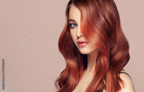 Fotografiet Beauty redhead girl with long  and   shiny wavy red hair
