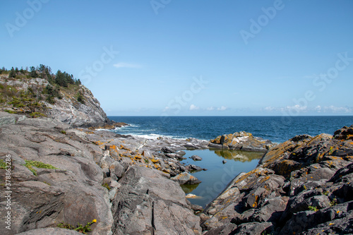 Rocky coast by the edge of the ocean in summer