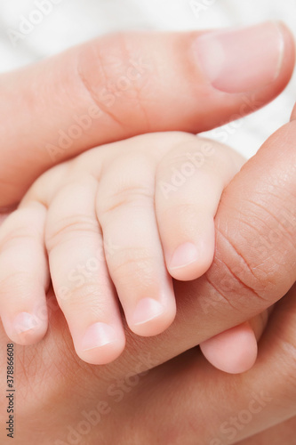 Woman holding her baby s hand