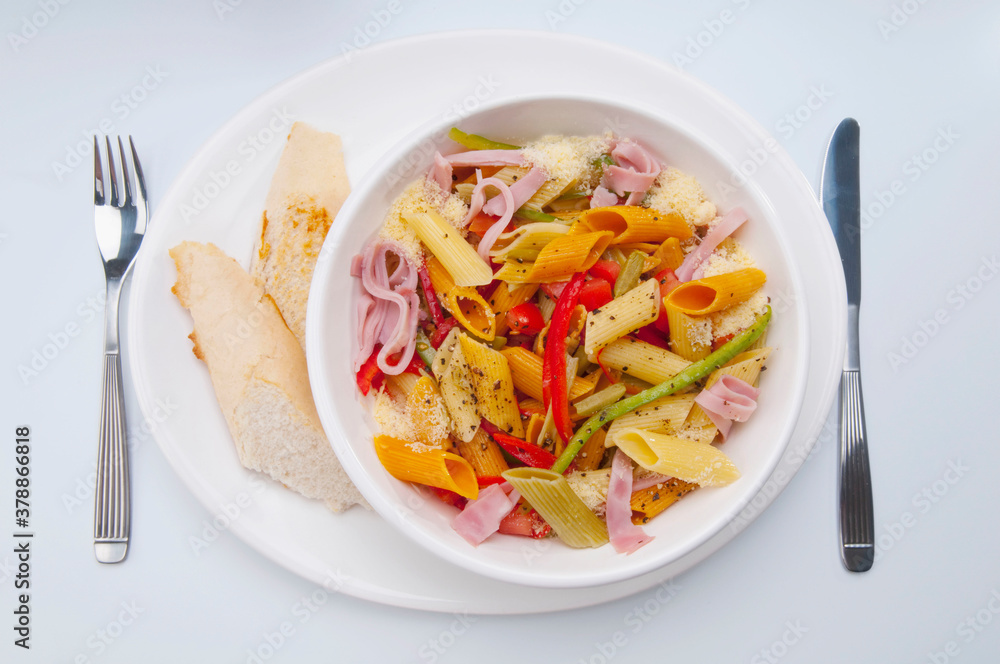 High angle view of a bowl of penne pasta and ham salad High angle view of a bowl of penne pasta and ham salad