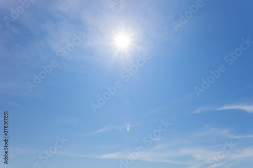 Nature background of clouds with clear blue sky background and sun with lens flare Good weather day background.