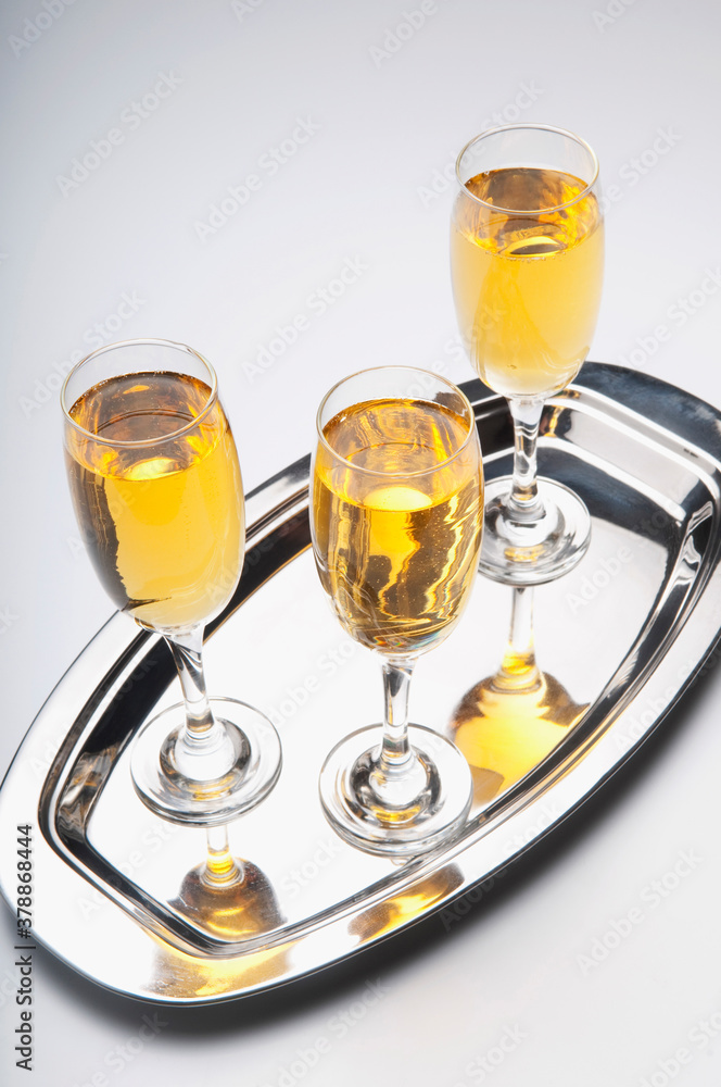 High angle view of three glasses of champagne on a tray High angle view of three glasses of champagne on a tray
