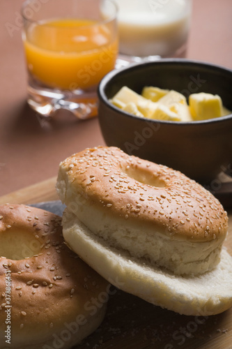 Close-up of bread with butter and glasses of juice