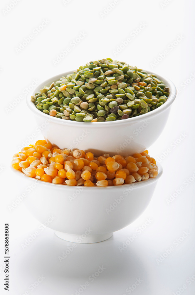 Close-up of bowls of green lentils and corn kernels Close-up of bowls of green lentils and corn kernels