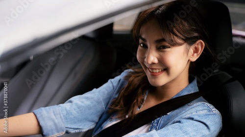 Young Asian woman driving a car