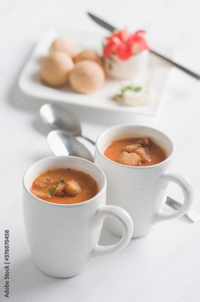 Two cups of tomato soup with bread cubes Two cups of tomato soup with bread cubes