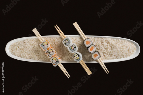Close-up of various sushi with chopsticks on a plate