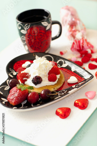 High angle view of pancakes with strawberries and cream
