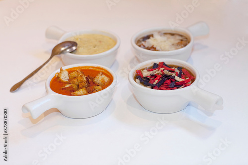High angle view of four assorted soups