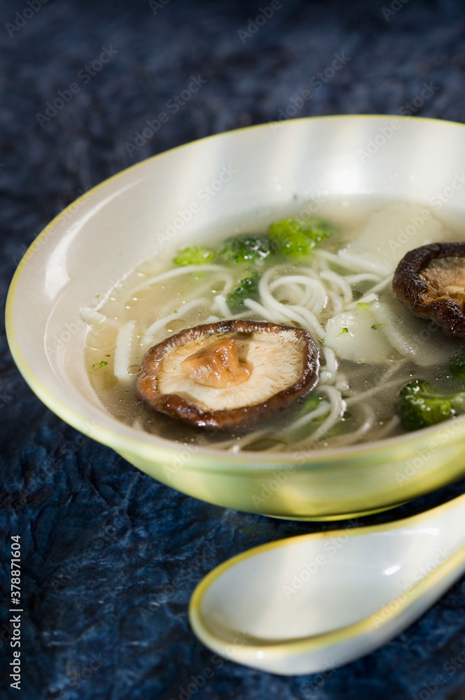High angle view of a bowl of mushroom and noodle soup High angle view of a bowl of mushroom and noodle soup