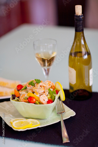 Close-up of shrimp salad served with white wine