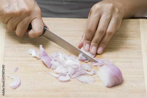 Close-up of a woman chopping an onion