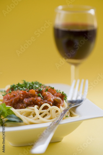 Close-up of spaghetti and meat with red wine