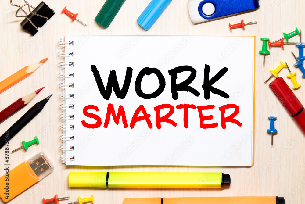 Notebook on table with text inside: Work Smart Notebook on table with text inside: Work Smart