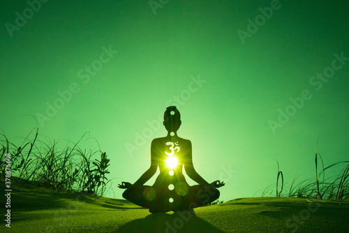 yoga position silhouette in contrasting sun, Heart chakra