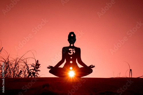 yoga position silhouette in contrasting sun, Root Chakra
