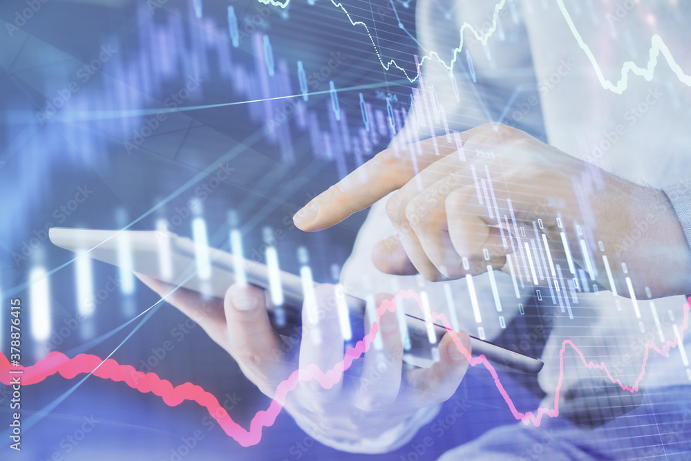 Double exposure of man's hands holding and using a digital device and forex graph drawing. Financial market concept. Double exposure of man's hands holding and using a digital device and forex graph drawing. Financial market concept.