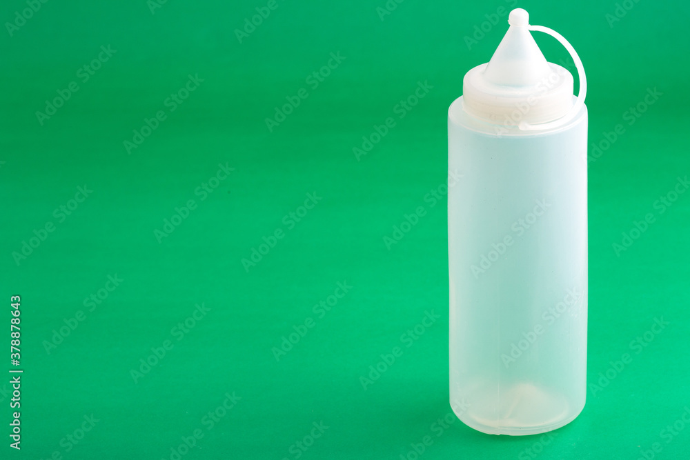 Container Dispenser Plastic Sauce; Photo On Green Background. Container Dispenser Plastic Sauce; Photo On Green Background.