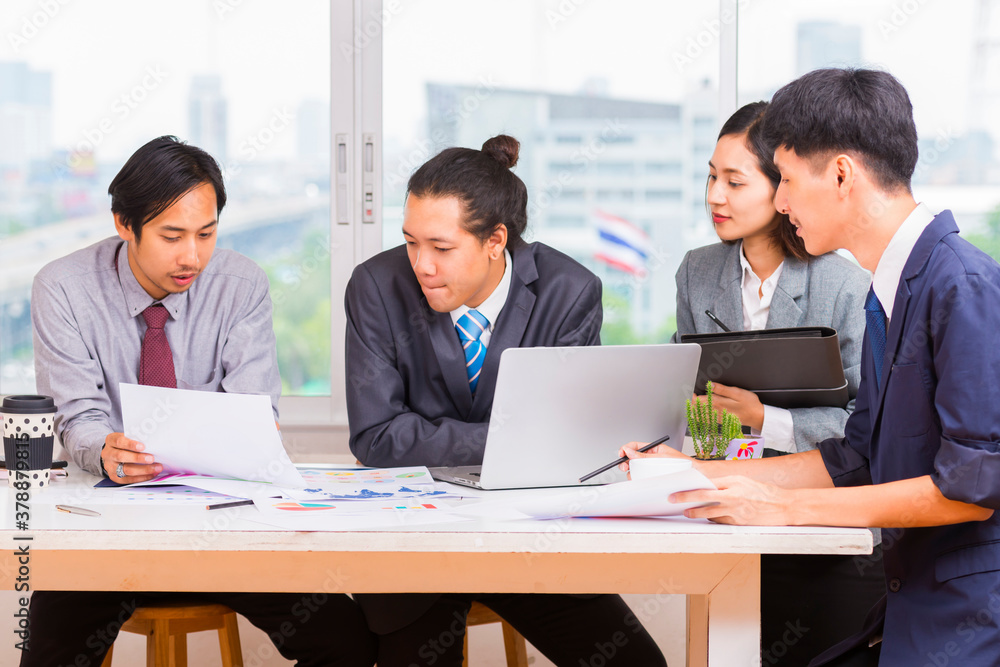 Business People Analyzing Statistics Financial Concept - Group of young confident business people analyzing data using computer in thailand. Business People Analyzing Statistics Financial Concept - Group of young confident business people analyzing data using computer in thailand.