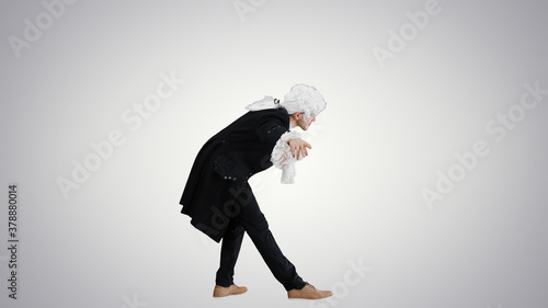 Man dressed as a courtier of 17-18 century greets someone on gra