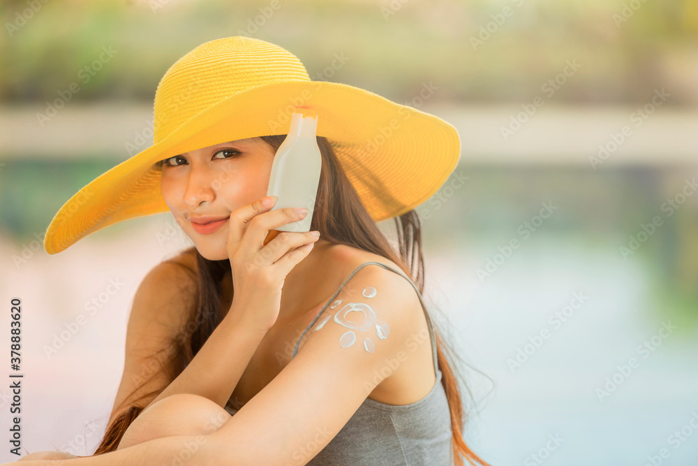 Woman applying sunscreen cream on her body outdoors under sunshine on beautiful summer day and leave space for adding your content. Skincare, Body Sun protection, Sunscreen sunblock.