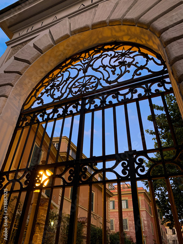 Beautiful old stone and wrought iron doorways of Italian roman villa at dusk in Rome, Italy
