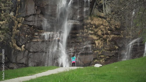 Woman enjoying the spectacular view of short and steep torrente, Acquafraggia in Valchiavenna, Italy. photo