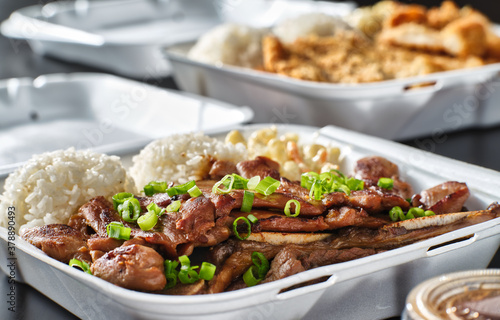 hawaiian bbq in take out container with mix of barbecue meats