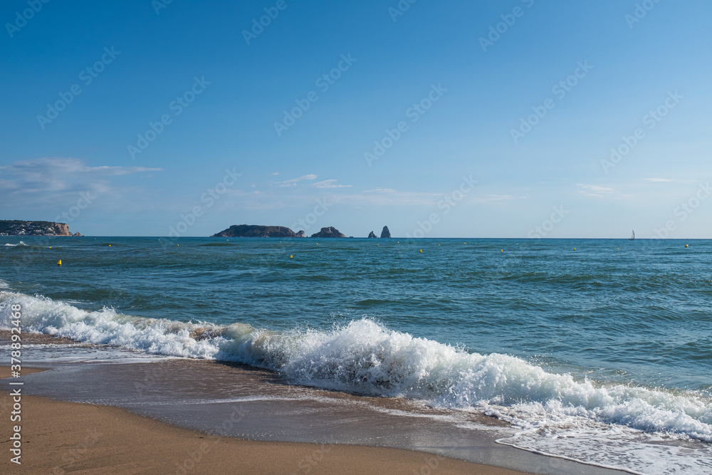 Brave water wave sea on a sandy beach on a blue sunny landscape