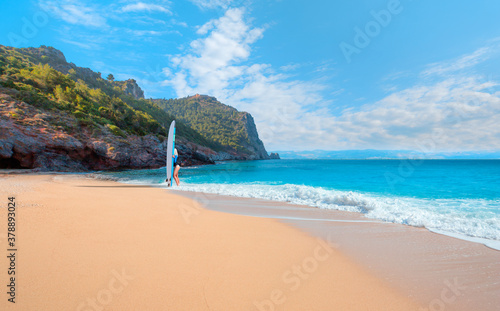 Beautiful surfer woman on the beach at sunny day - Cleopatra beach  Alanya