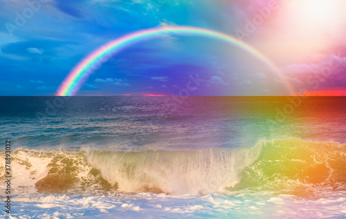 Beautiful landscape with turquoise sea with double sided rainbow at sunset