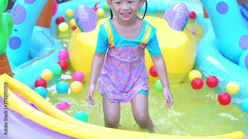 child playing with colorful balloons
