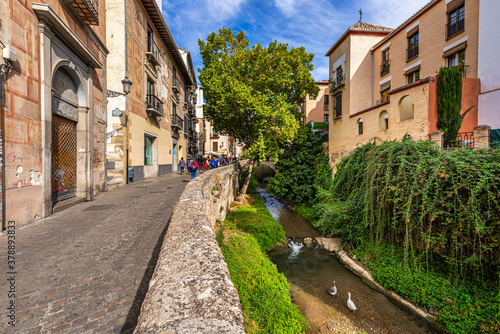Granada, Spain October 17th, 2019. View on Carrera del Darro Street, the street that runs along the Darro River, and on the ancient buildings of the historic city center. © Alessandro