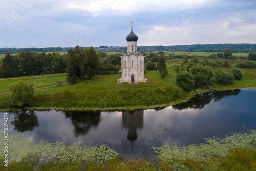 View of the ancient Church of the Intercession on the Nerl on a cloudy August morning (shot from a quadcopter). Bogolyubovo, Russia