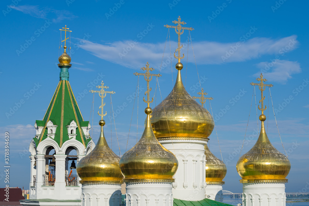 The belfry and domes of the Church of the Nativity of John the Baptist  against the blue sky. Nizhniy Novgorod, Russia