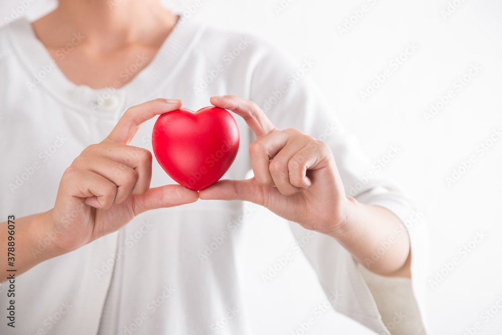 Woman holding red heart symbol of World heart day. White background isolated. Woman holding red heart symbol of World heart day. White background isolated.