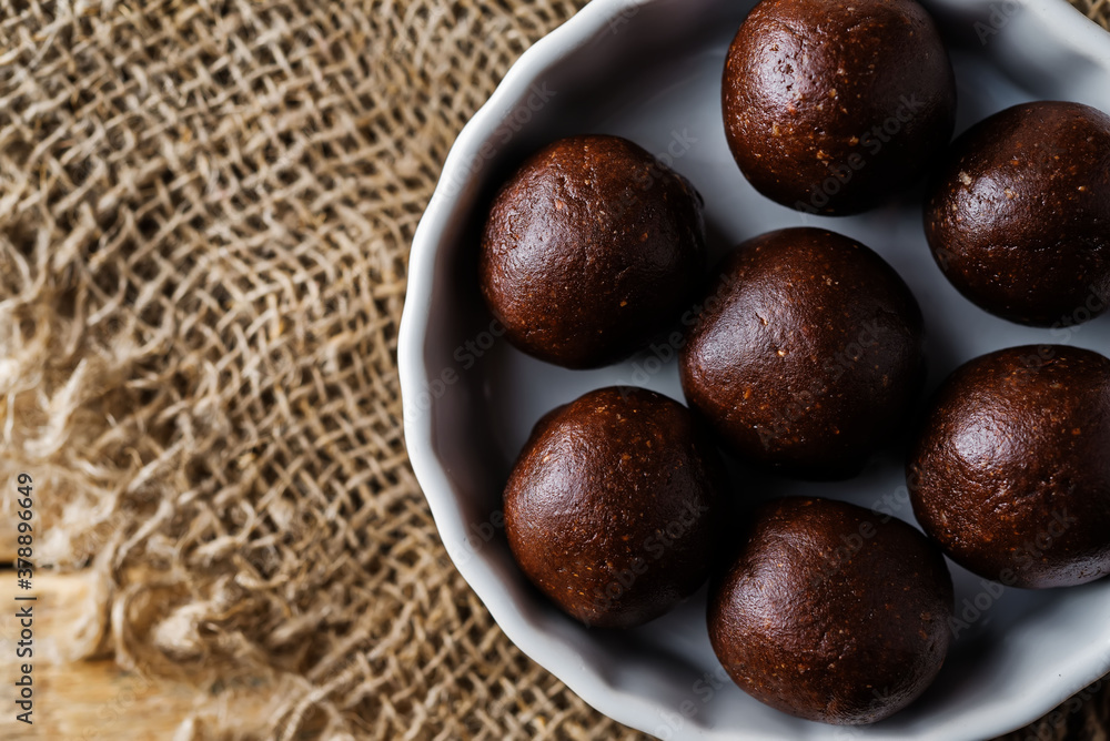 Fototapeta premium Dates walnuts chocolate raw balls in a plate