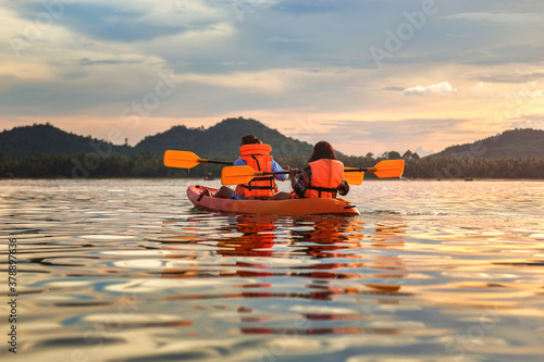 Tourist paddling the kayak on the sea among the beautiful scenery during sunset at koh pitak , chumphon province in Thailand. This is very popular for photographers and tourists.