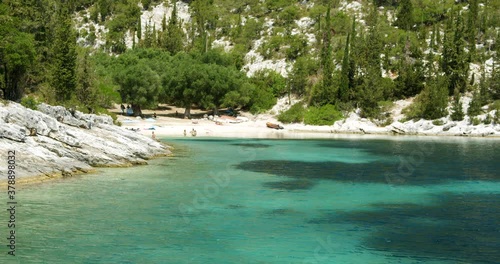 Beautiful landscape with green forest and emerald water lagoon of Foki Fiskardo beach, Kefalonia, Ionian islands, Greece. photo