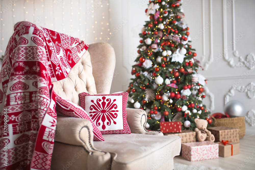 Gifts in boxes close-up under a Christmas tree with red and white decor in a white living room. New year, European style, kitchen decor. Space for text, selective focus Gifts in boxes close-up under a Christmas tree with red and white decor in a white living room. New year, European style, kitchen decor. Space for text, selective focus