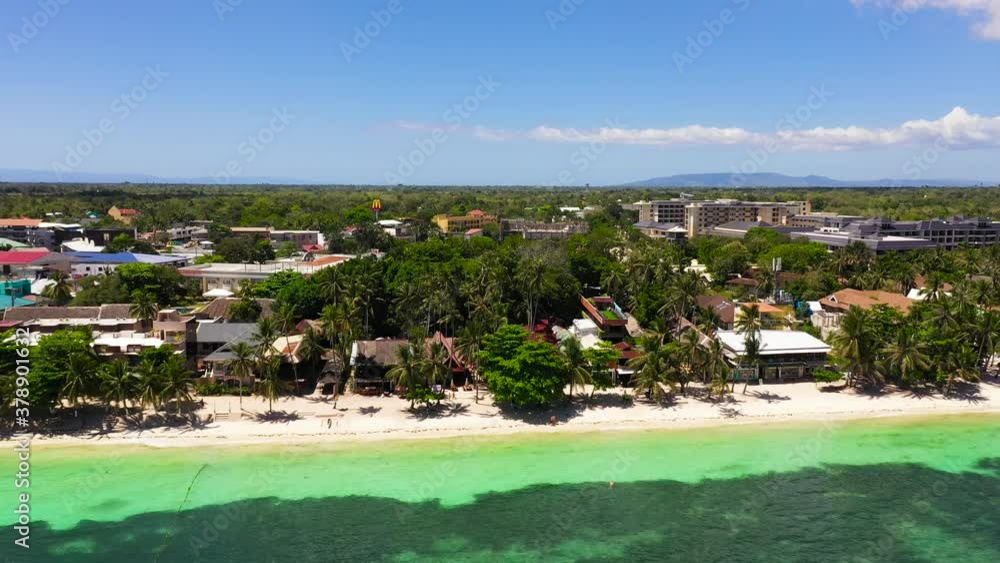 Beautiful sandy beach and turquoise water in Panglao island, Bohol, Philippines. Alona beach with palm trees. Beautiful sandy beach and turquoise water in Panglao island, Bohol, Philippines. Alona beach with palm trees.