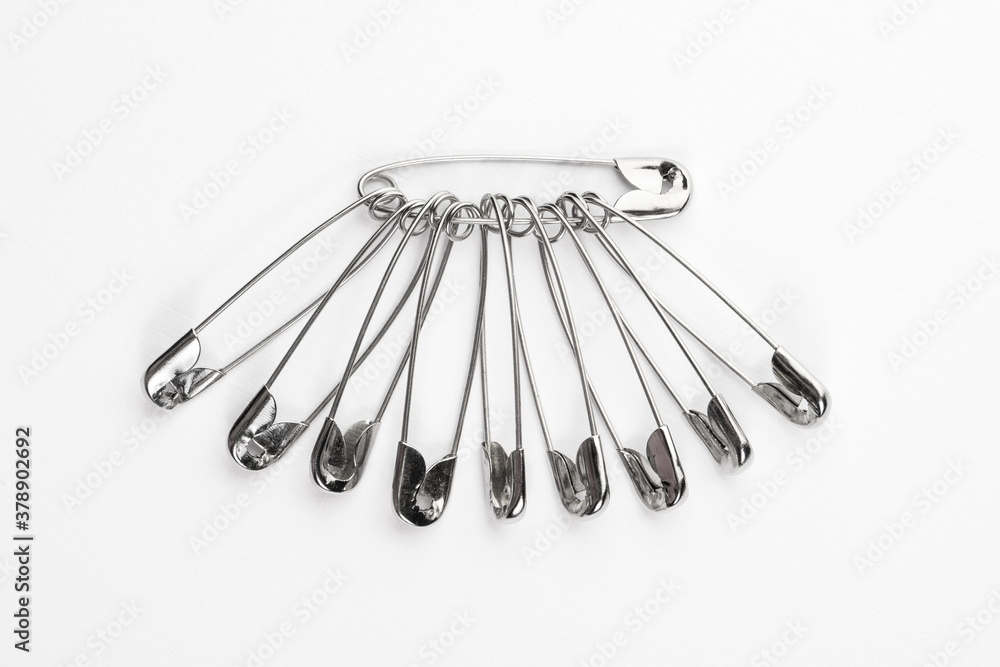 set of metal pins for clothing, isolate on a white background set of metal pins for clothing, isolate on a white background