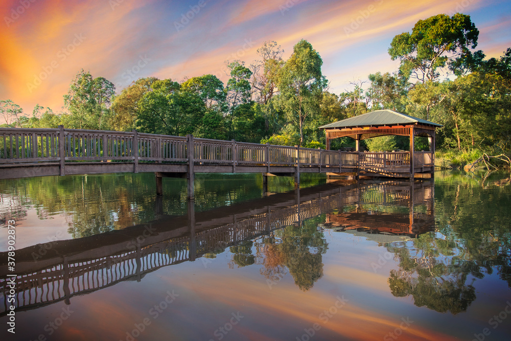Fototapeta premium A sunny day photo of a bridge reflected in the water