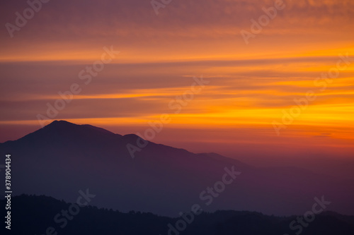 alone mount top silhouette on a dramatic sunset background © Yuriy Kulik